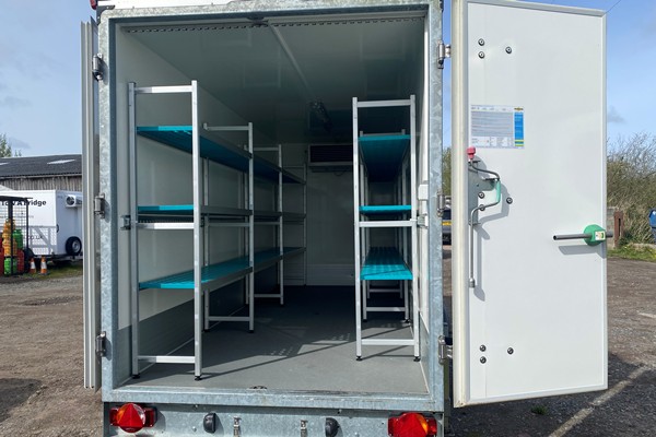 Interior of a refrigerated trailer with metal shelves