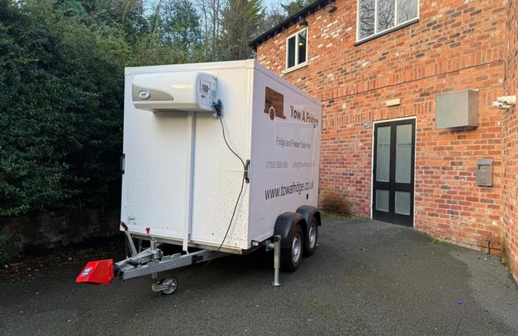 A refrigerated trailer parked in a driveway.