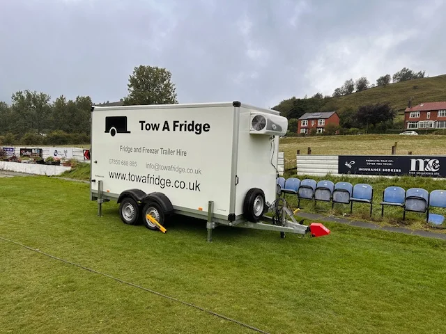 Tow A Fridge trailer for fridge and freezer hire on a grassy field.